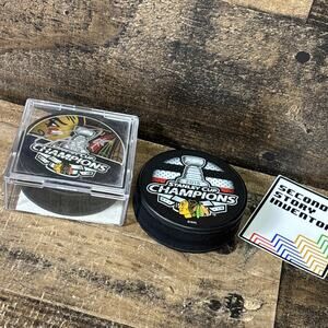 2013 Andrew Shaw Autographed Stanley Cup Champions Puck + 2015 Champions Puck